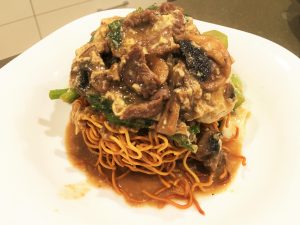 Ee-mein with beef and mushroom sauce